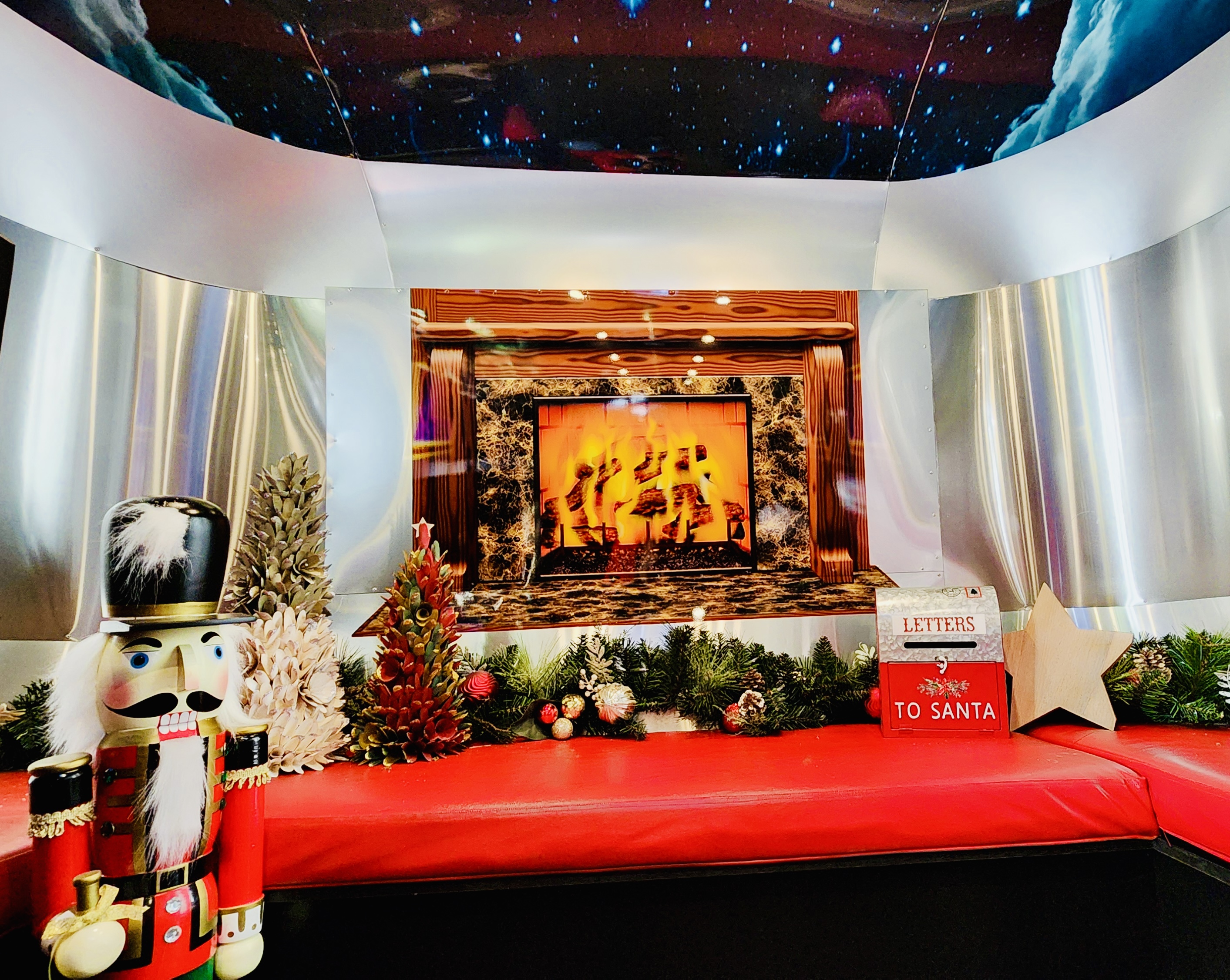 The Polar Express conductor, in a festive uniform, walking in front of the Polar Express Long Island train